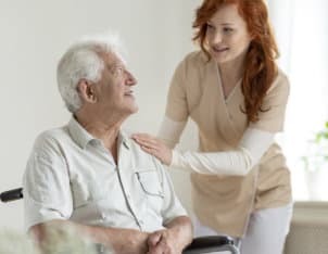 an elderly man and a caregiver woman