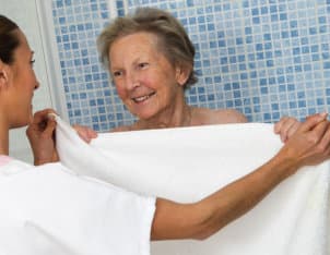 a caregiver woman helping an elderly woman