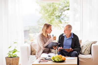 caregiver and senior man  having a conversation regarding to the medicine