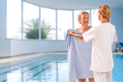 caregiver giving a towel to senior