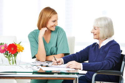 woman and senior smiling to each other