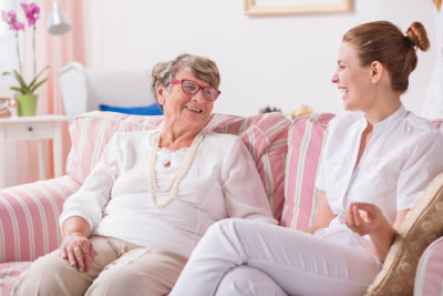 caregiver and senior woman smiling