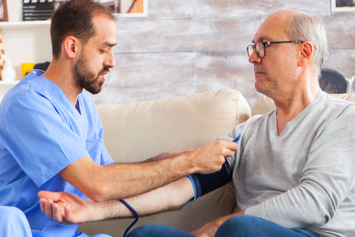 man monitoring the blood pressure of senior