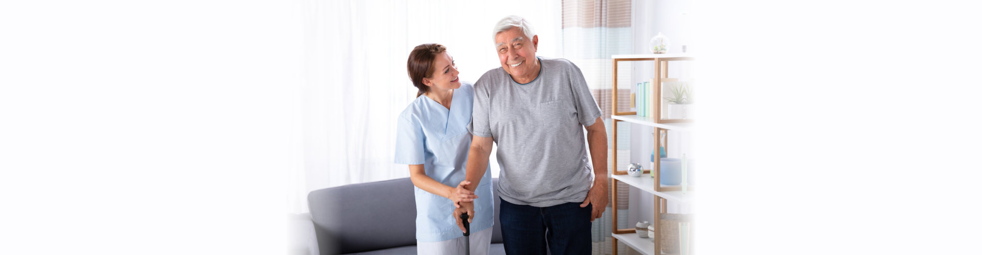 woman helping senior in walking