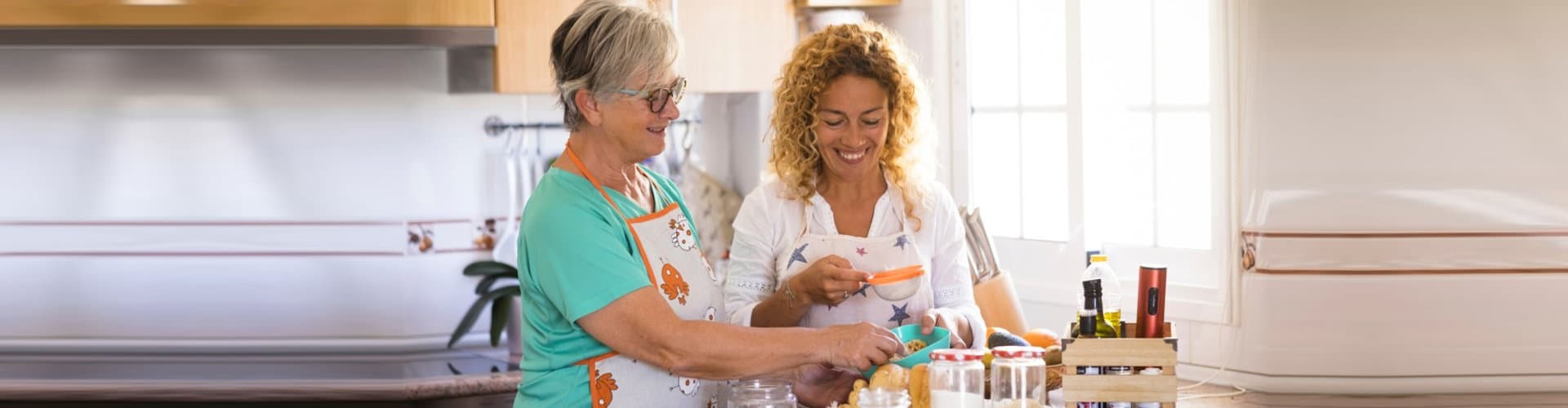 woman and senior cooking together