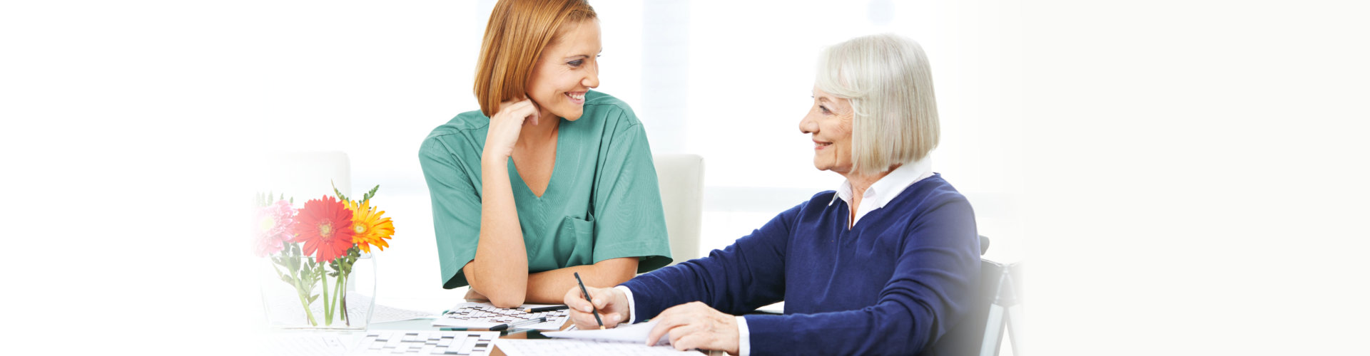 woman and senior smiling to each other